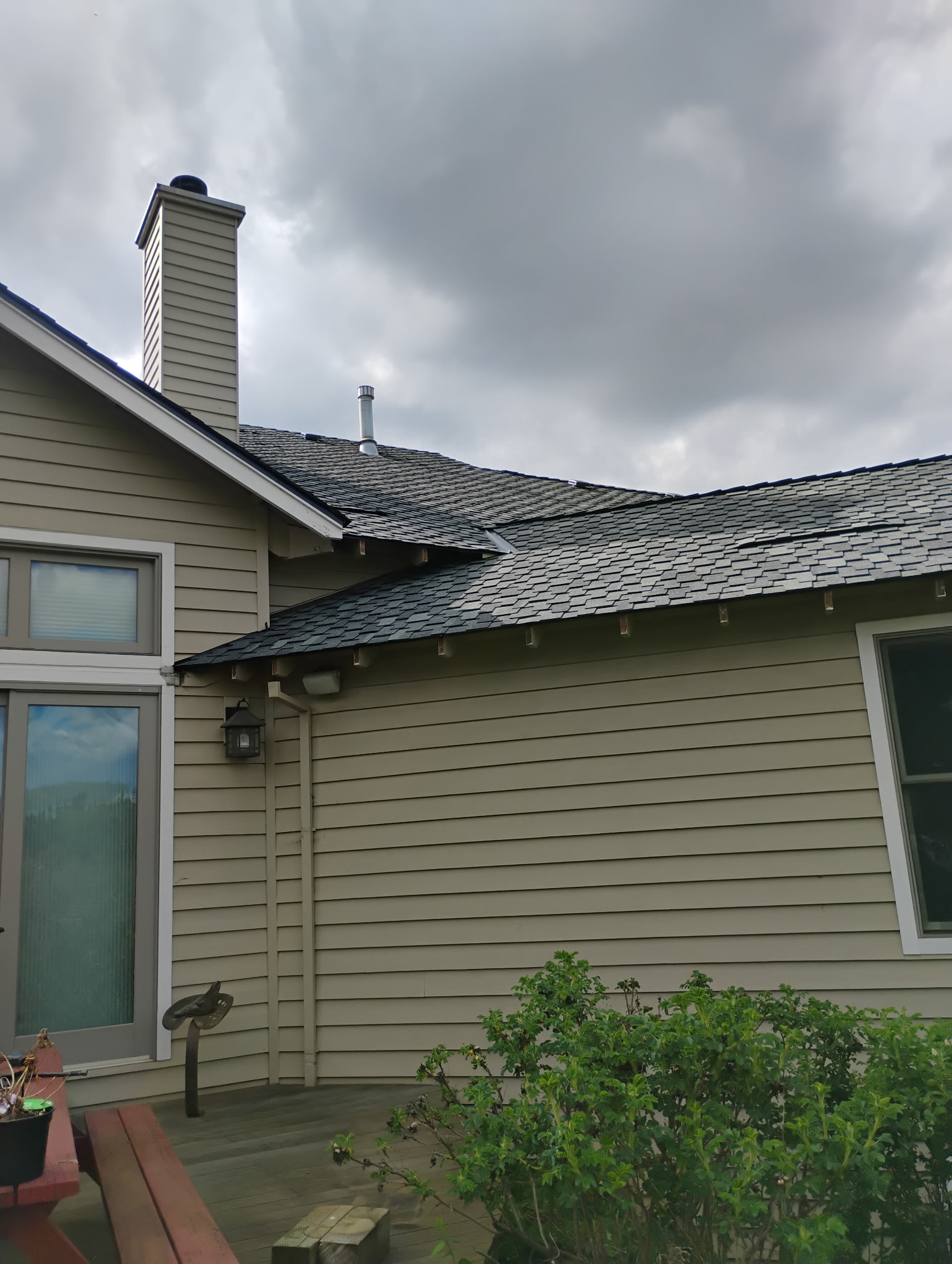 Completed shingle roof with chimney flashing detail